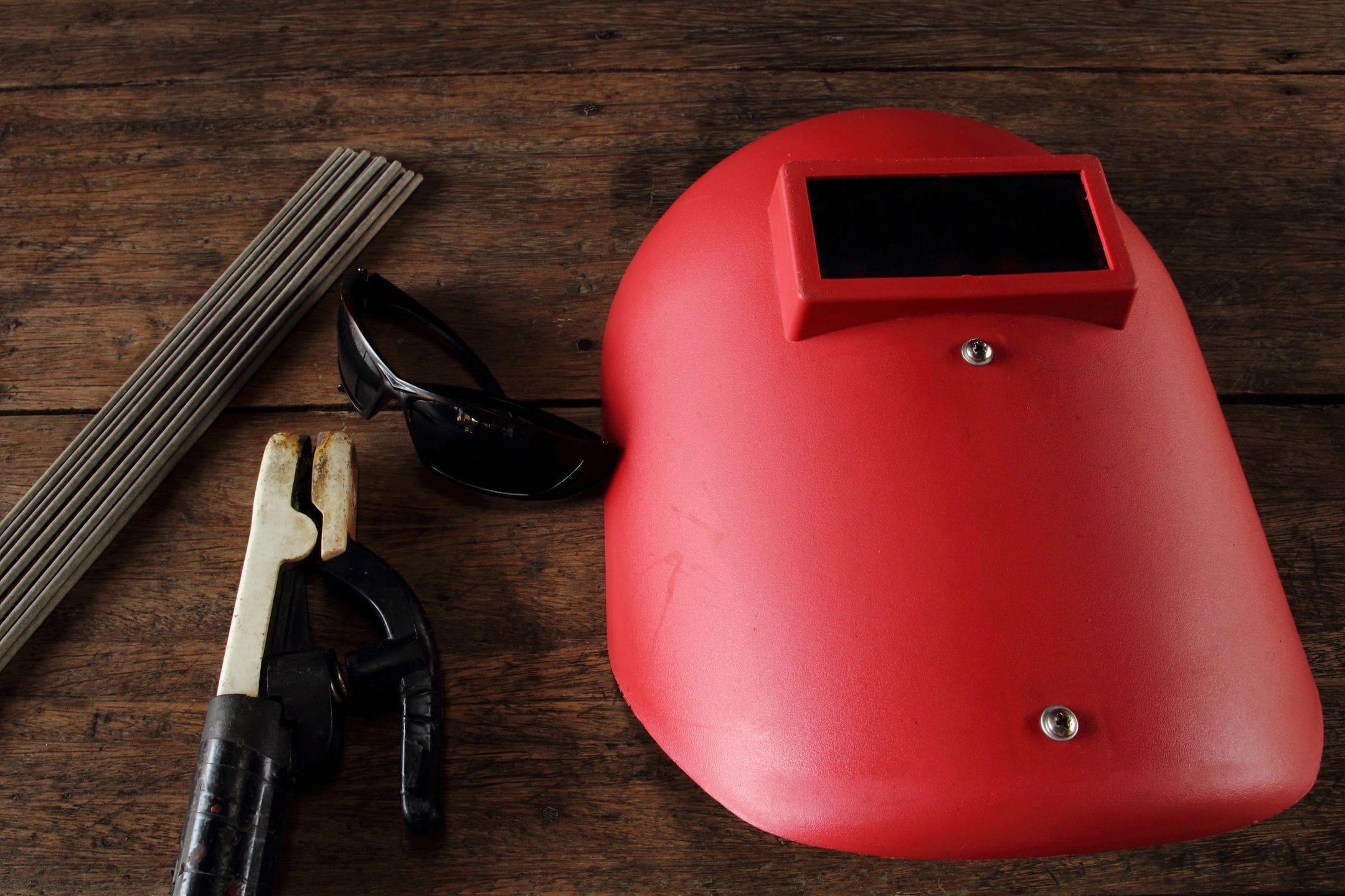 A red helmet and some tools on top of a table.