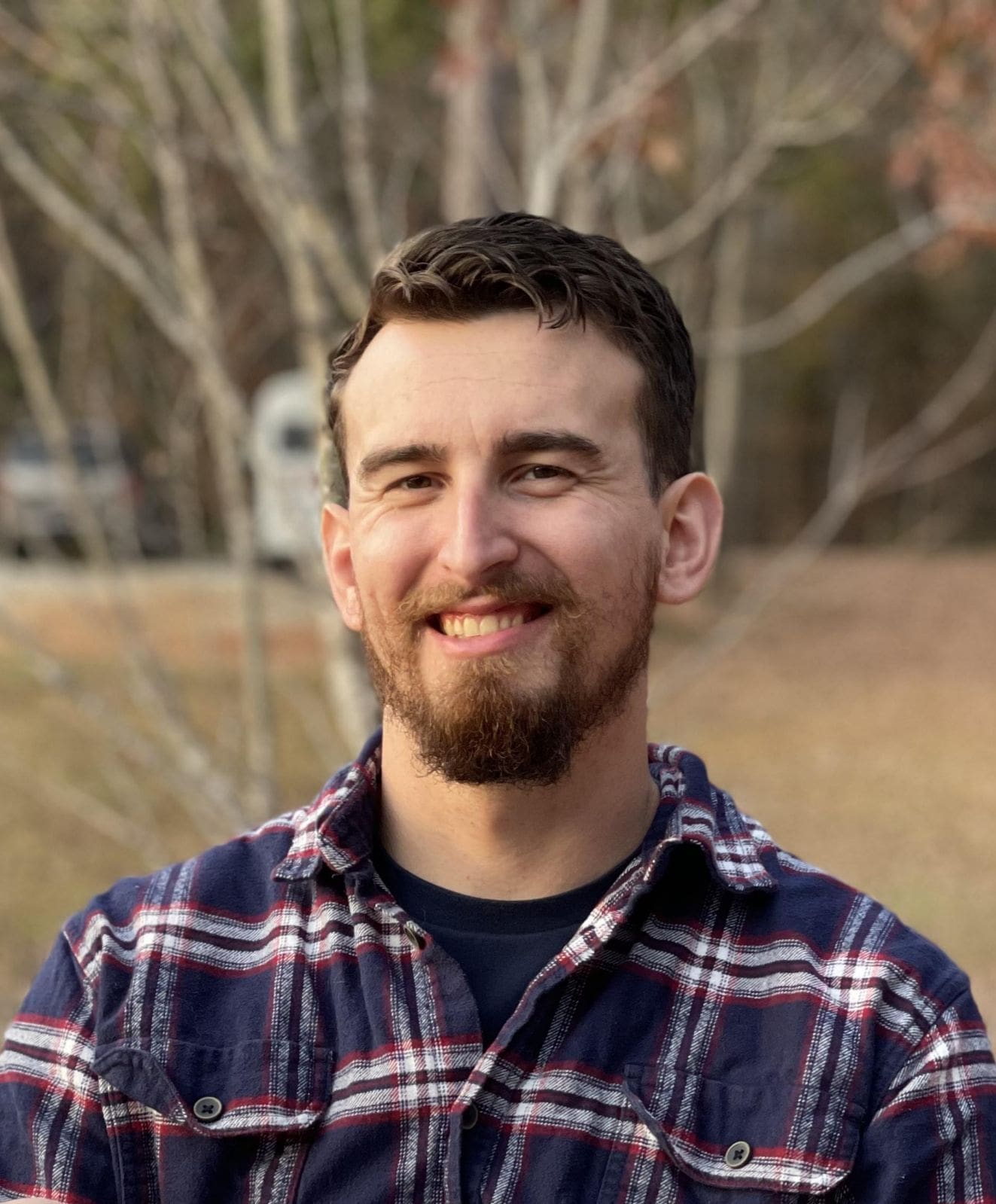 A man with a beard and plaid shirt